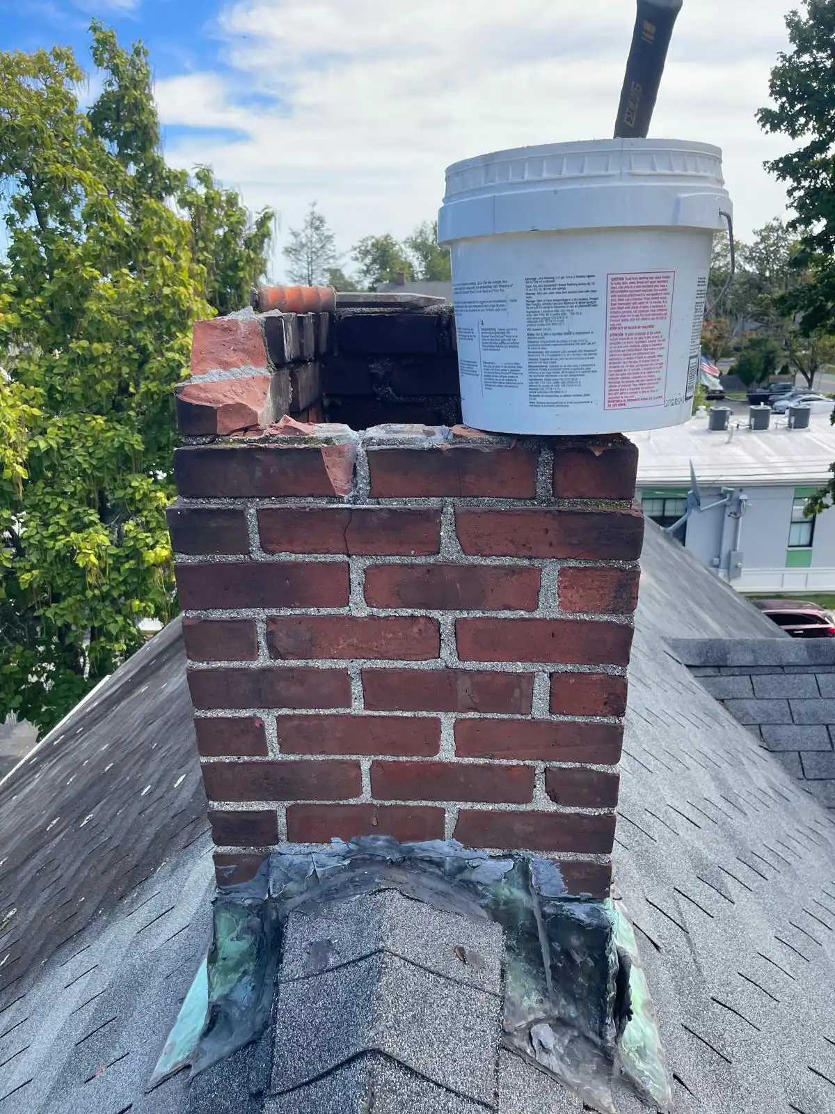 Damaged chimney flashing causing roof leak